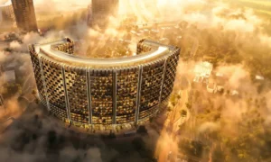 Binghatti Wraith at Al Jaddaf by Binghatti aerial exterior view of the illuminated curved residential tower surrounded by clouds in Dubai - Presented by Tohid Fetrat