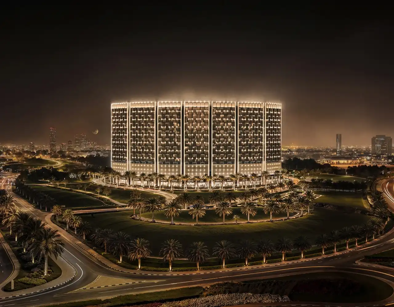 Binghatti Wraith at Al Jaddaf by Binghatti illuminated residential tower surrounded by landscaped grounds and palm lined roads at night in Dubai - Presented by Tohid Fetrat