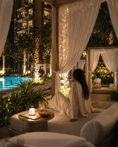 Binghatti Wraith at Al Jaddaf by Binghatti private poolside cabana with ambient lighting and luxury resort atmosphere at night in Dubai - Presented by Tohid Fetrat