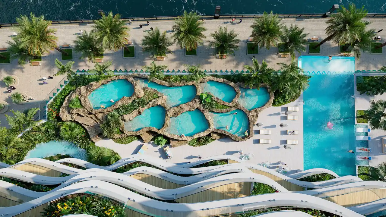 CHIC Tower by DAMAC in Business Bay lagoon style pools and infinity swimming pool surrounded by tropical landscaping in Dubai Presented by Tohid Fetrat