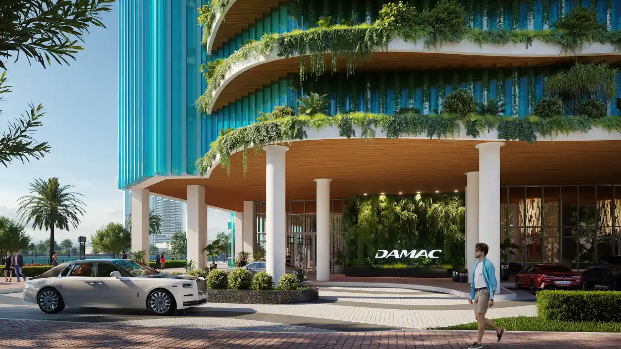 CHIC Tower by DAMAC in Business Bay main entrance with landscaped podium luxury drop off area and contemporary architecture in Dubai Presented by Tohid Fetrat