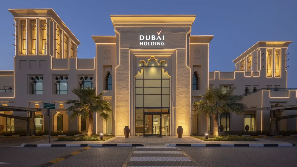 Dubai Holding headquarters building with illuminated contemporary architecture at dusk Presented by Tohid Fetrat