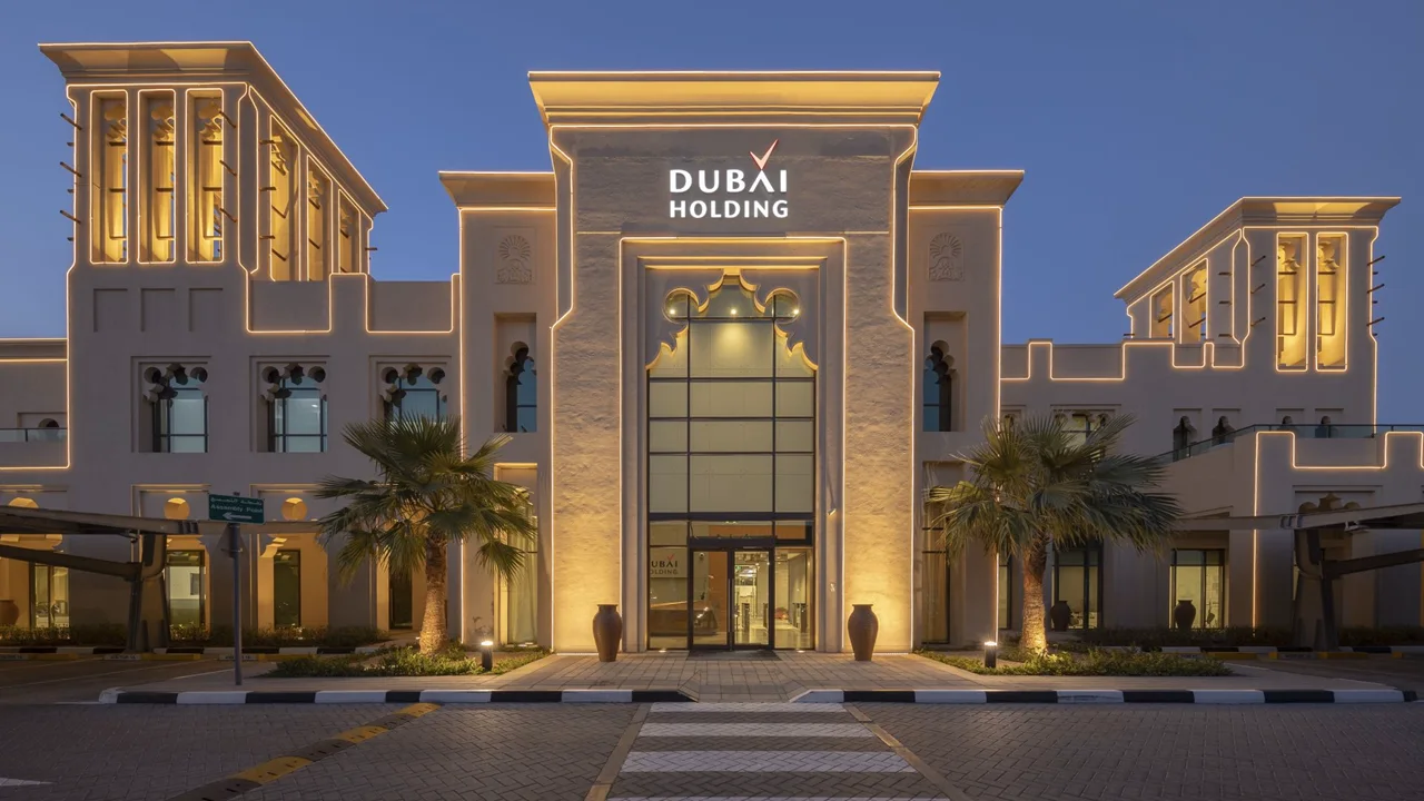 Dubai Holding headquarters building with illuminated contemporary architecture at dusk Presented by Tohid Fetrat