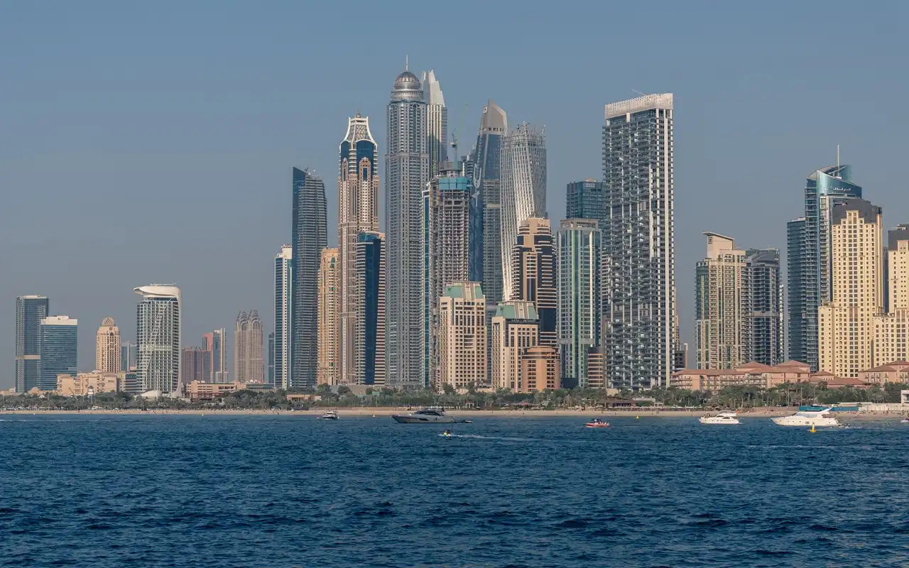 Dubai Real Estate ROI Guide featuring Dubai waterfront skyline premium residential towers and property investment market insights Presented by Tohid Fetrat