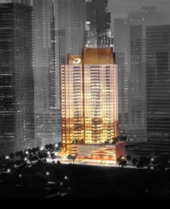 Elegance Tower by DAMAC in Downtown Dubai featuring an illuminated tower facade against the city skyline at night in Dubai - Presented by Tohid Fetrat