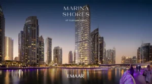 Marina Shores at Dubai Marina by Emaar Properties illuminated waterfront tower and skyline view at night in Dubai Presented by Tohid Fetrat