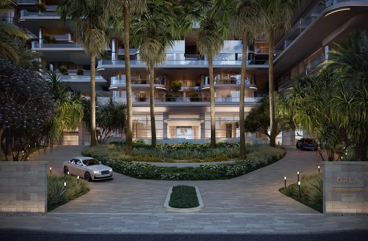 Grand arrival entrance at ORLA, Dorchester Collection Dubai featuring landscaped gardens, luxury drop-off area, palm-lined driveway, and exclusive residential access. Presented by Tohid Fetrat