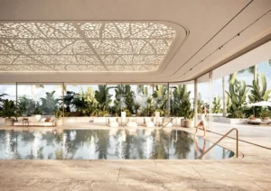 Indoor resort-style swimming pool at ORLA, Dorchester Collection Dubai featuring tropical landscaping, wellness facilities, luxury relaxation spaces, and beachfront-inspired design. Presented by Tohid Fetrat