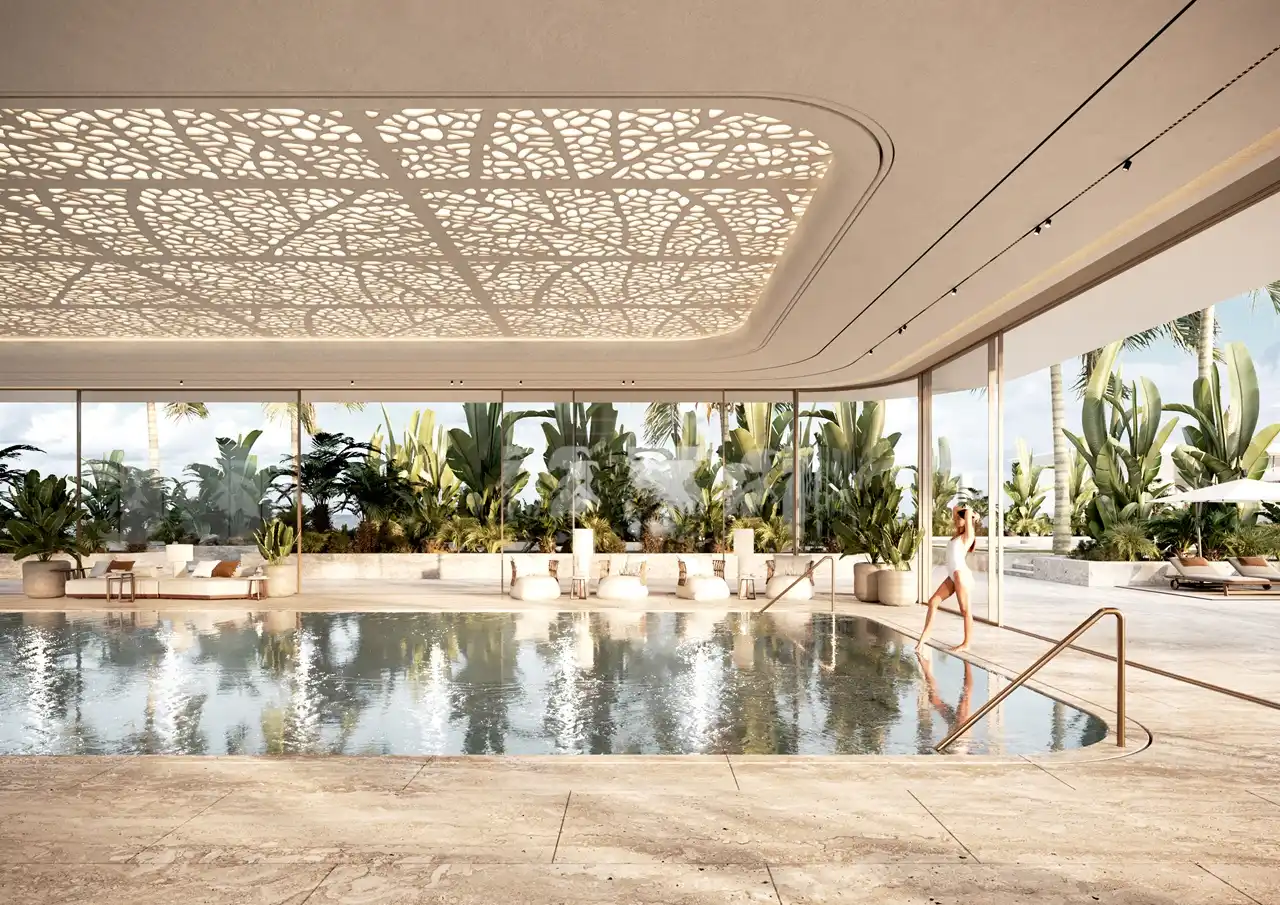 Indoor resort-style swimming pool at ORLA, Dorchester Collection Dubai featuring tropical landscaping, wellness facilities, luxury relaxation spaces, and beachfront-inspired design. Presented by Tohid Fetrat