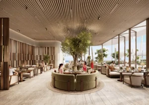 ORLA, Dorchester Collection, Dubai by OMNIYAT beach club lounge featuring luxury seating areas, coastal dining spaces, landscaped interiors, and panoramic beachfront views in Dubai. Presented by Tohid Fetrat