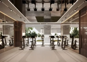 ORLA, Dorchester Collection, Dubai by OMNIYAT cycling fitness studio featuring advanced stationary bikes, mirrored walls, contemporary interiors, and premium wellness facilities in Dubai. Presented by Tohid Fetrat