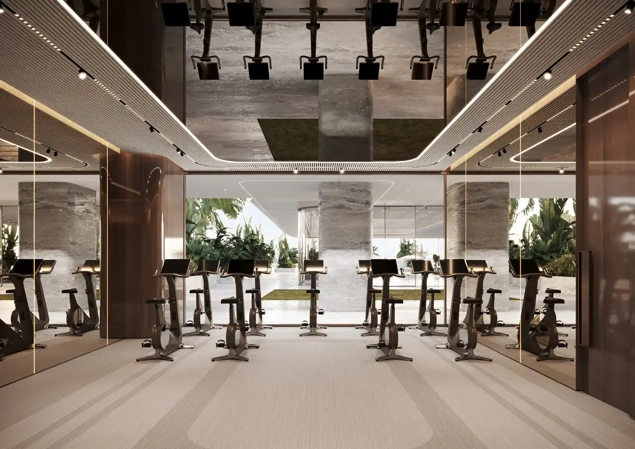 ORLA, Dorchester Collection, Dubai by OMNIYAT cycling fitness studio featuring advanced stationary bikes, mirrored walls, contemporary interiors, and premium wellness facilities in Dubai. Presented by Tohid Fetrat