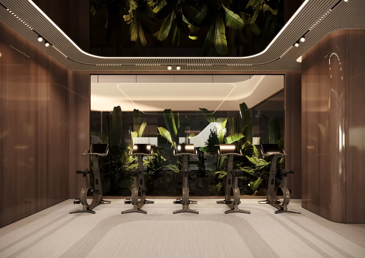 ORLA, Dorchester Collection, Dubai by OMNIYAT cycling studio featuring premium stationary bikes, contemporary fitness interiors, ambient lighting, and landscaped garden views in Dubai. Presented by Tohid Fetrat
