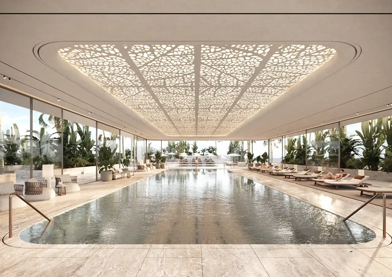 ORLA, Dorchester Collection, Dubai by OMNIYAT indoor swimming pool with luxury lounge seating, floor to ceiling glazing, tropical landscaping, and elegant wellness design in Dubai. Presented by Tohid Fetrat