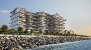 ORLA, Dorchester Collection, Dubai by OMNIYAT waterfront residences overlooking the coastline with expansive terraces, glass facades, and landscaped surroundings in Dubai. Presented by Tohid Fetrat