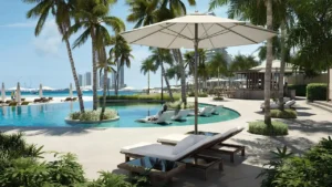 Palm Beach Tower 1 at Palm Jumeirah by Nakheel beachfront infinity pool surrounded by palm trees and resort style amenities in Dubai Presented by Tohid Fetrat