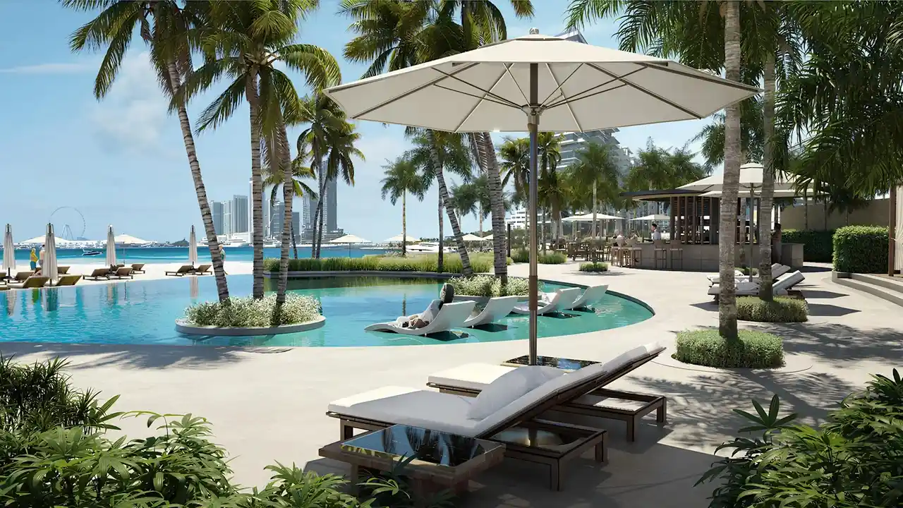 Palm Beach Tower 1 at Palm Jumeirah by Nakheel beachfront infinity pool surrounded by palm trees and resort style amenities in Dubai Presented by Tohid Fetrat