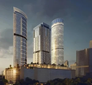 Palm Beach Tower 1 at Palm Jumeirah by Nakheel illuminated tower facade and contemporary architecture at dusk in Dubai Presented by Tohid Fetrat