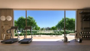 Palm Central Frond N Residences at Palm Jebel Ali by Nakheel fitness center with garden views, modern exercise equipment and floor to ceiling windows in Dubai - Presented by Tohid Fetrat