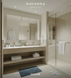 Savanna at Dubai Creek Harbour by Emaar Properties contemporary bathroom with double vanity, walk in glass shower, and premium interior finishes in Dubai Presented by Tohid Fetrat
