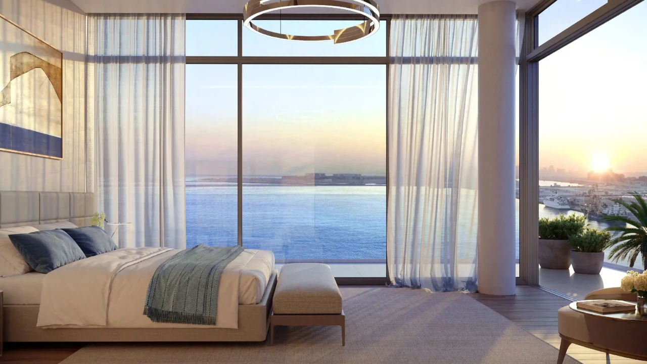 ANWA Aria by OMNIYAT luxury bedroom with floor to ceiling windows overlooking the waterfront and Dubai skyline in Dubai Presented by Tohid Fetrat