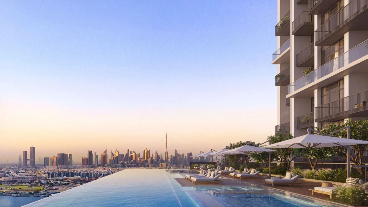 ANWA Aria by OMNIYAT infinity pool with panoramic Dubai skyline views luxury sun loungers and landscaped pool deck in Dubai Presented by Tohid Fetrat