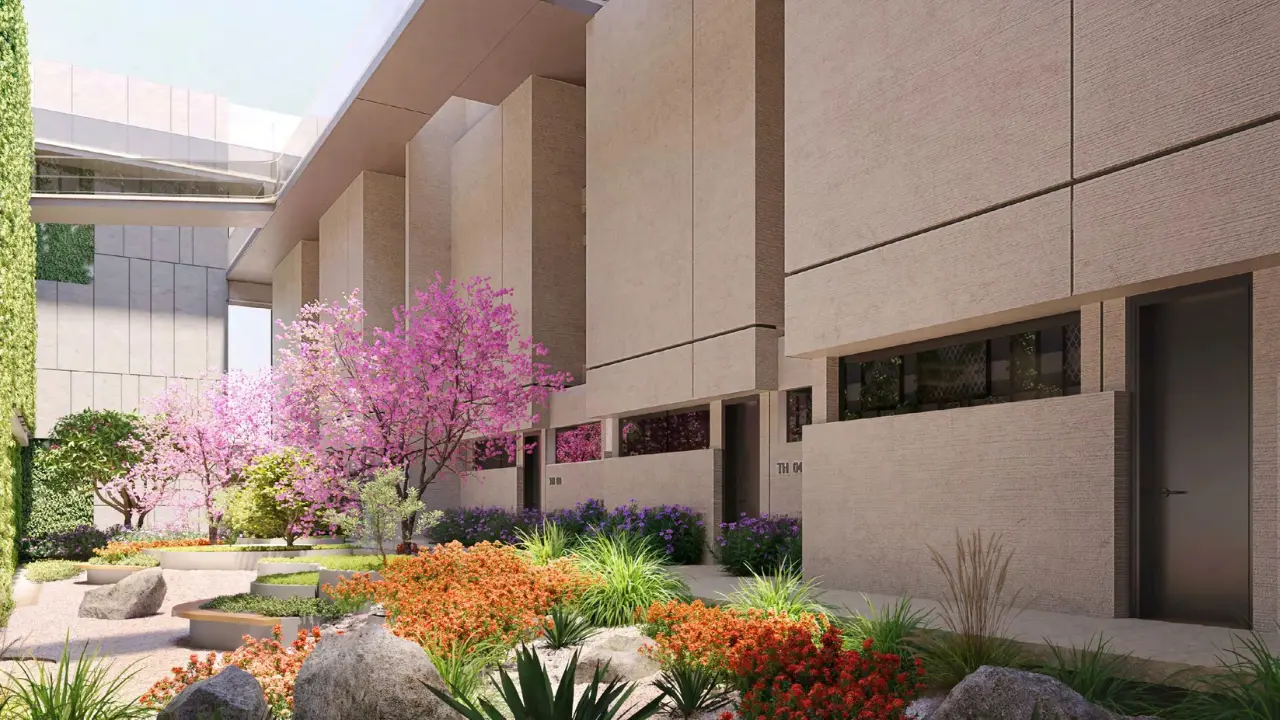 ANWA Aria by OMNIYAT landscaped courtyard with flowering trees contemporary architecture and lush garden pathways in Dubai Presented by Tohid Fetrat