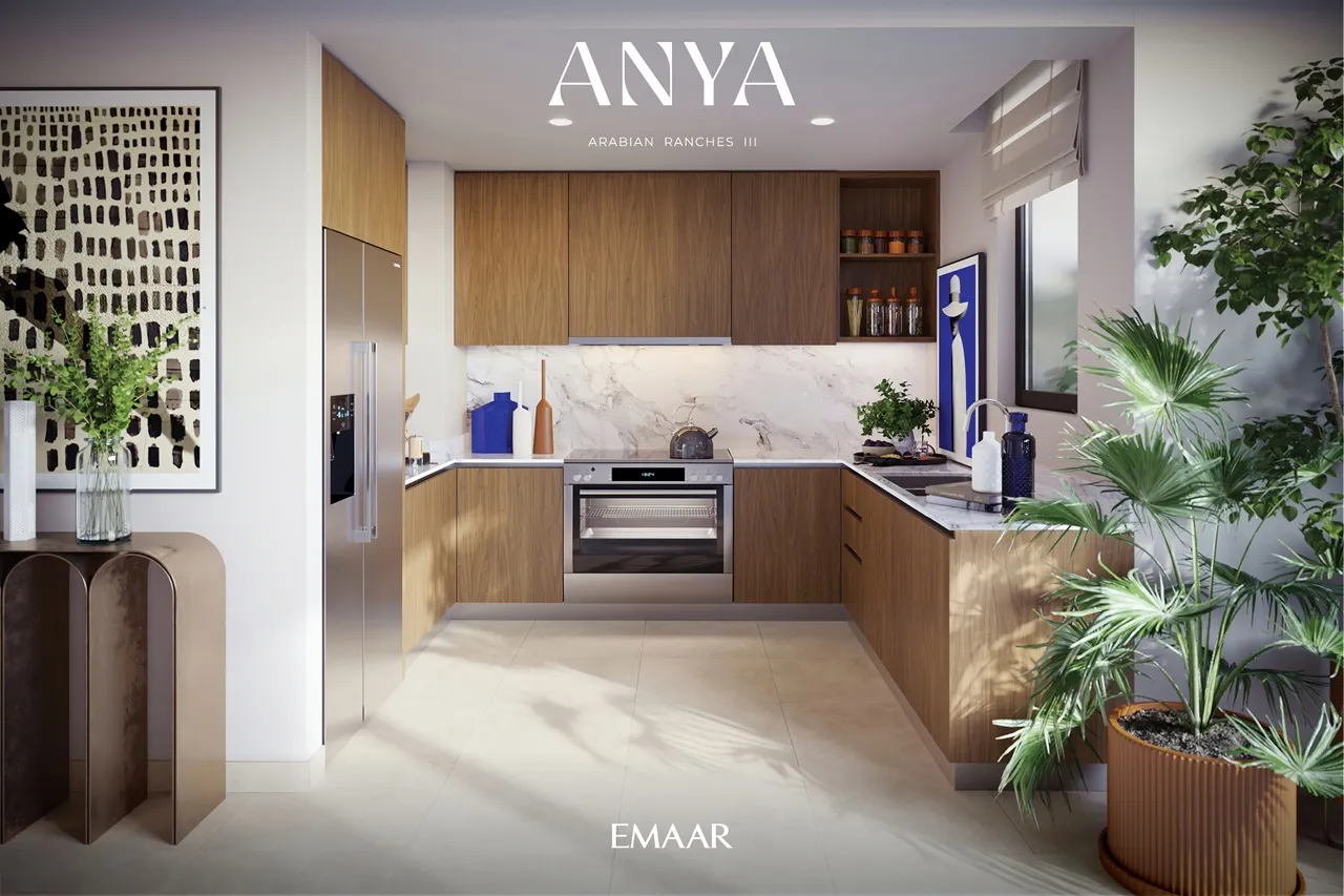 Anya at Arabian Ranches 3 by Emaar Properties contemporary kitchen interior with wood cabinetry marble backsplash and modern appliances in Dubai Presented by Tohid Fetrat