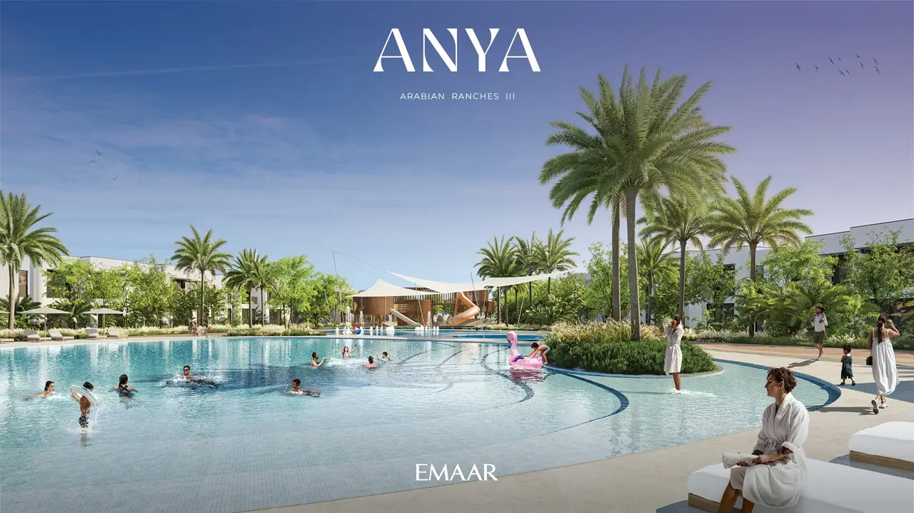 Anya at Arabian Ranches 3 by Emaar Properties resort style swimming pool with palm trees sun loungers and landscaped leisure areas in Dubai Presented by Tohid Fetrat