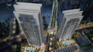Creek Gate at Dubai Creek Harbour by Emaar Properties aerial night view of twin residential towers with landscaped podium, swimming pools and surrounding waterfront in Dubai - Presented by Tohid Fetrat