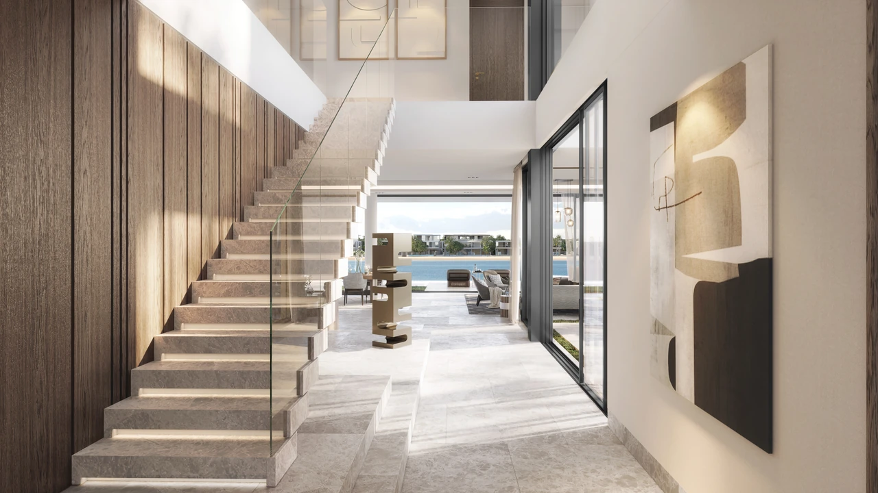 Frond A by Nakheel in Palm Jebel Ali Blue Jay villa entrance hall with sculptural stone staircase timber panelling wall art and water view beyond in Dubai - Presented by Tohid Fetrat