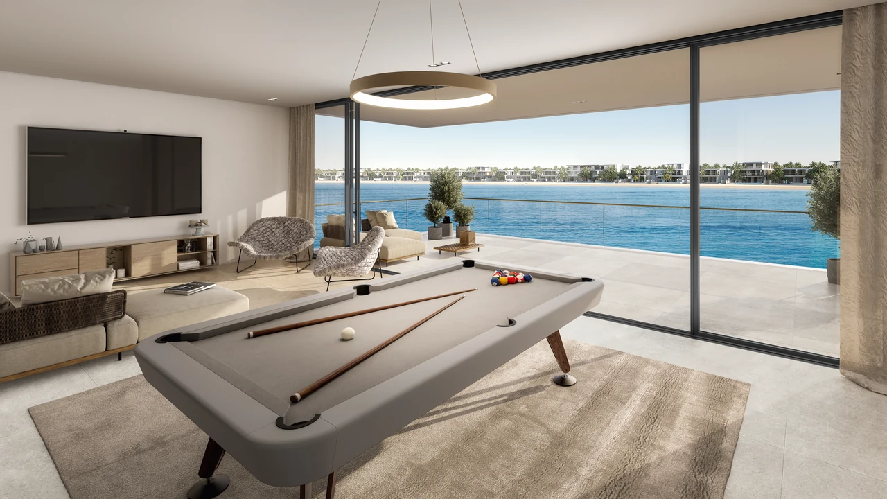 Frond A by Nakheel in Palm Jebel Ali Blue Jay villa games room with billiards table lounge seating and full height glazing to the water in Dubai - Presented by Tohid Fetrat