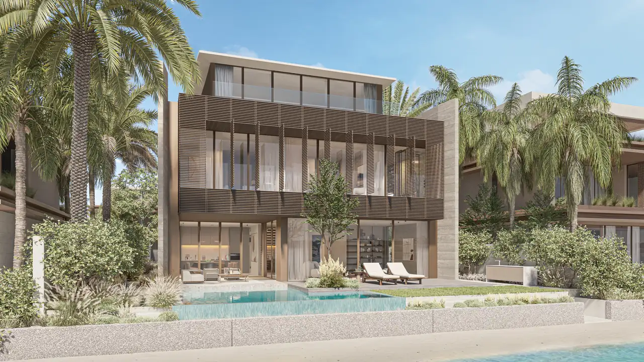 Frond A by Nakheel in Palm Jebel Ali Cobalt villa exterior viewed from the water with pool terrace timber louvred screens and mature planting in Dubai - Presented by Tohid Fetrat
