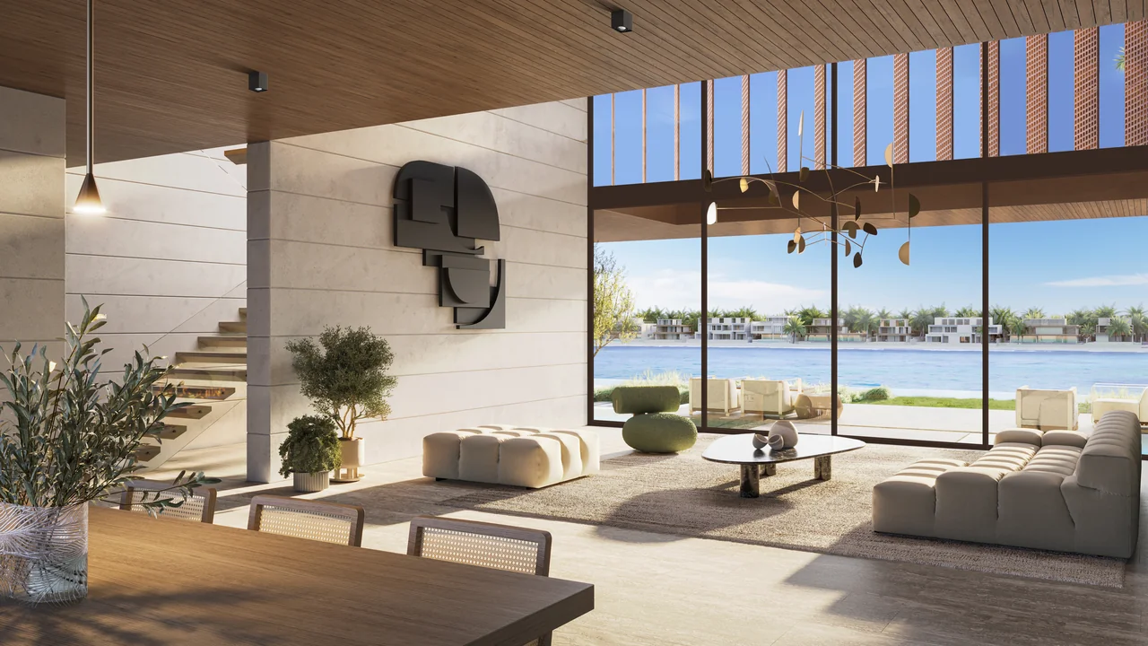 Frond A by Nakheel in Palm Jebel Ali Porcelain Roses villa double height living room with feature staircase sculptural mobile lighting and waterfront glazing in Dubai - Presented by Tohid Fetrat