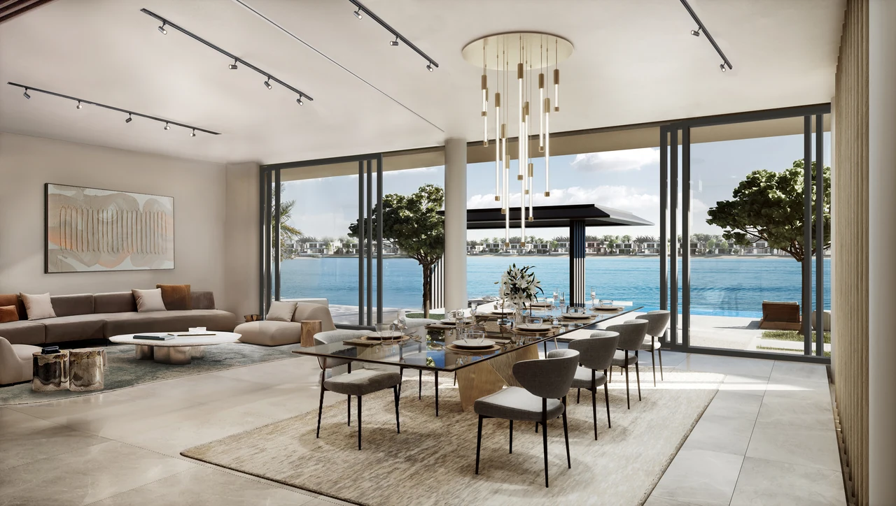 Frond A by Nakheel in Palm Jebel Ali Red Aurora villa living and dining space with layered seating statement chandelier and waterfront glazing in Dubai - Presented by Tohid Fetrat