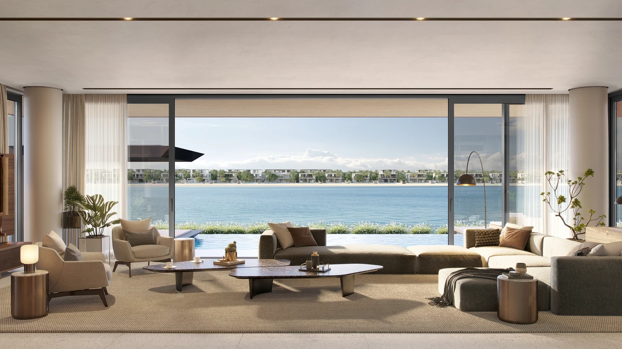 Frond C by Nakheel in Palm Jebel Ali Amber Reef villa living room framing the water through full height glazing with sculptural furniture in Dubai - Presented by Tohid Fetrat