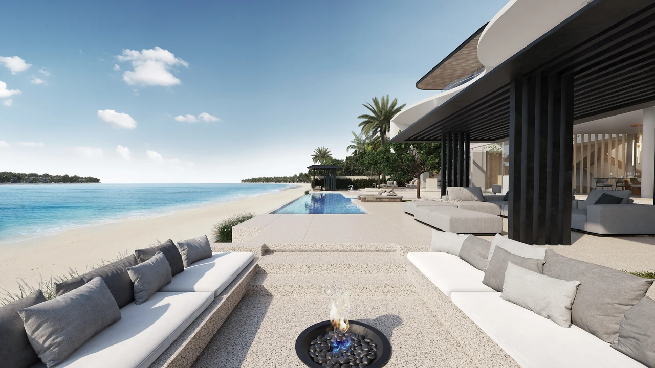 Frond C by Nakheel in Palm Jebel Ali Red Aurora villa exterior from the sea with warm stone facade pool terrace and direct beach access in Dubai - Presented by Tohid Fetrat