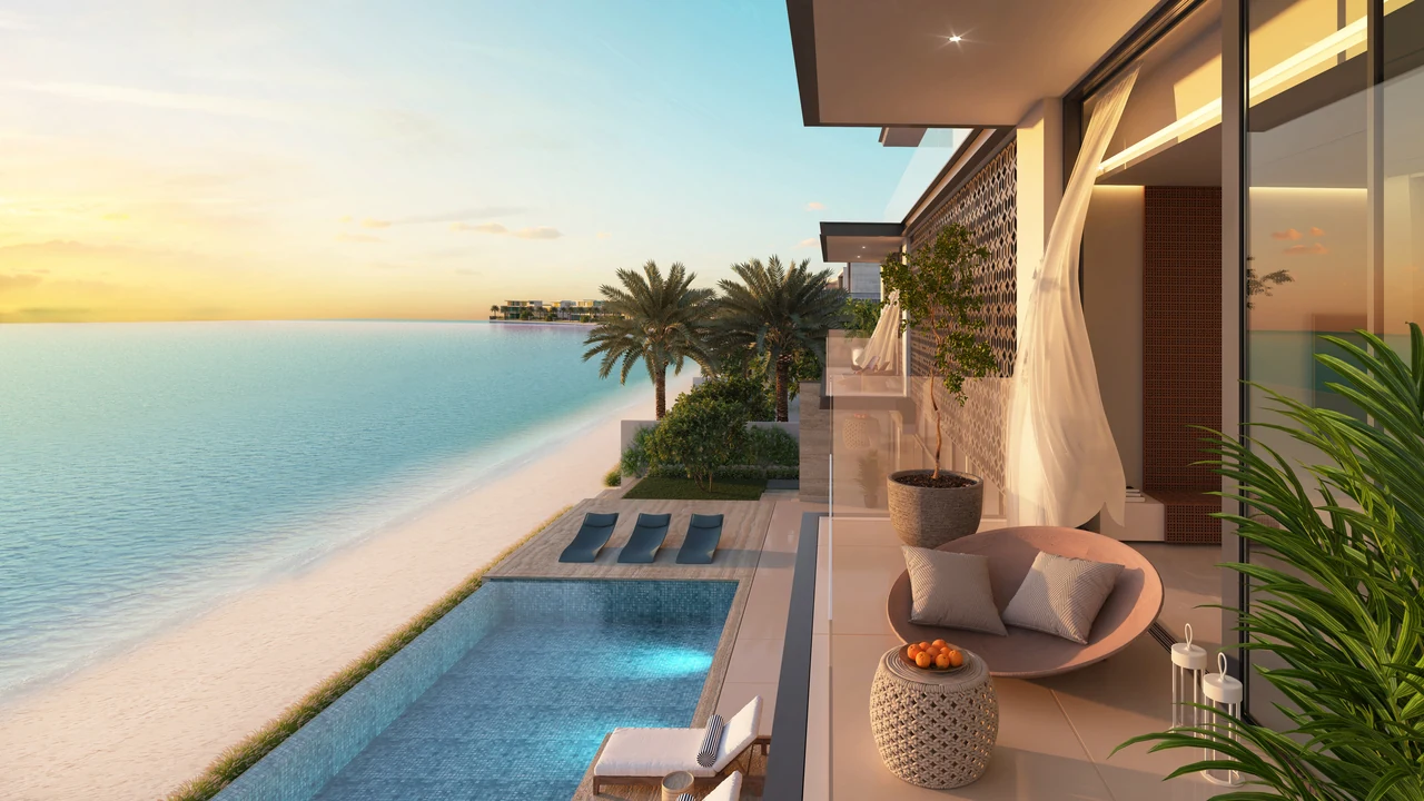 Frond C by Nakheel in Palm Jebel Ali Sunset Mirage villa pool deck and shaded outdoor lounge with sun loungers and open sea outlook in Dubai - Presented by Tohid Fetrat