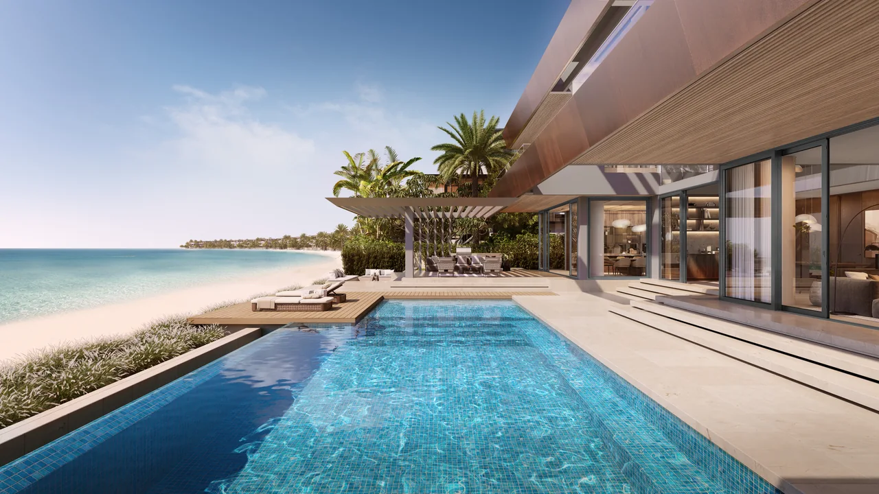 Frond F by Nakheel in Palm Jebel Ali Amber Reef villa pool terrace with sun loungers shaded seating and palm landscaping beside the sea in Dubai - Presented by Tohid Fetrat