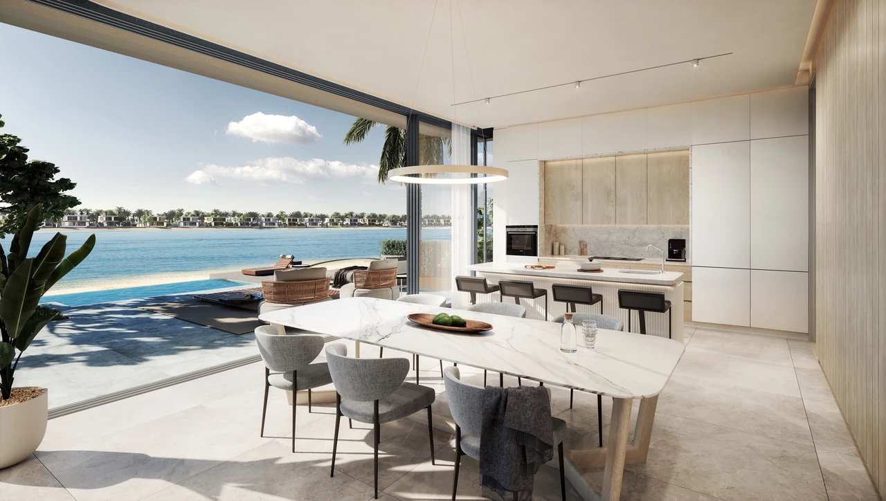Frond F by Nakheel in Palm Jebel Ali Red Aurora villa open plan kitchen and dining space with island seating handleless cabinetry and terrace access in Dubai - Presented by Tohid Fetrat