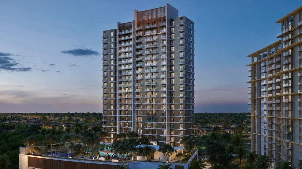 Golf Hillside by Emaar in Dubai Hills Estate golf course facing residential tower at dusk with illuminated facades landscaped podium and open fairway views in Dubai Presented by Tohid Fetrat