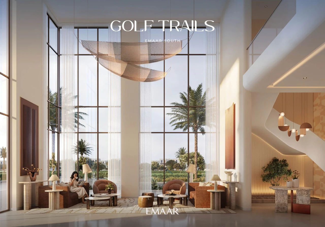 Golf Trails by Emaar in Emaar South clubhouse exterior in the evening with warm lighting glazed frontage and golf course backdrop in Dubai - Presented by Tohid Fetrat