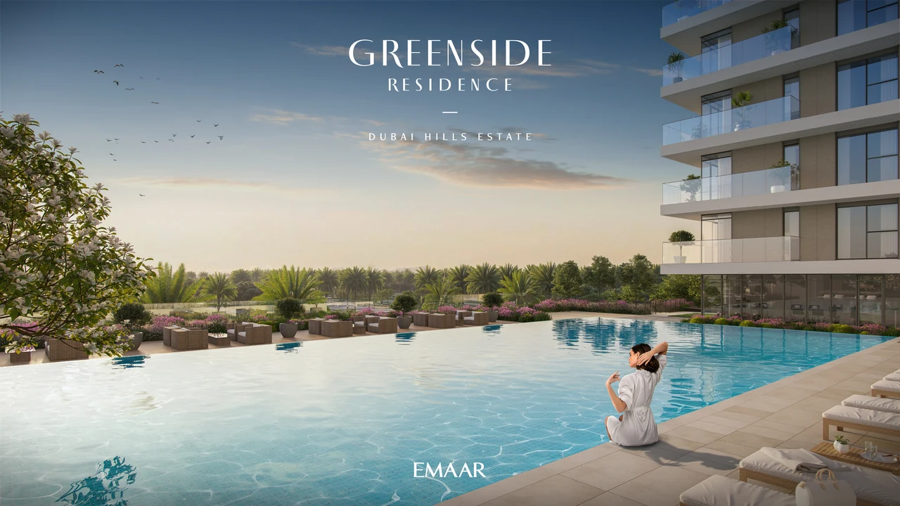 Greenside Residence by Emaar in Dubai Hills Estate outdoor swimming pool with sun loungers landscaped deck and greenery beside the residential buildings in Dubai - Presented by Tohid Fetrat