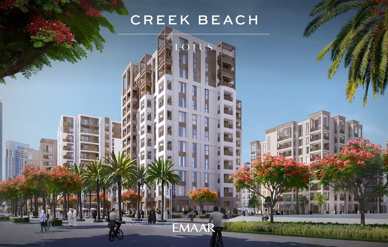 Lotus at Dubai Creek Harbour by Emaar Properties featuring the exterior of contemporary residential buildings surrounded by landscaped gardens, palm trees, and vibrant flowering trees in Dubai Presented by Tohid Fetrat