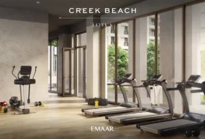 Lotus at Dubai Creek Harbour by Emaar Properties featuring a modern fitness center with treadmills, strength equipment, floor to ceiling windows, and garden views in Dubai Presented by Tohid Fetrat