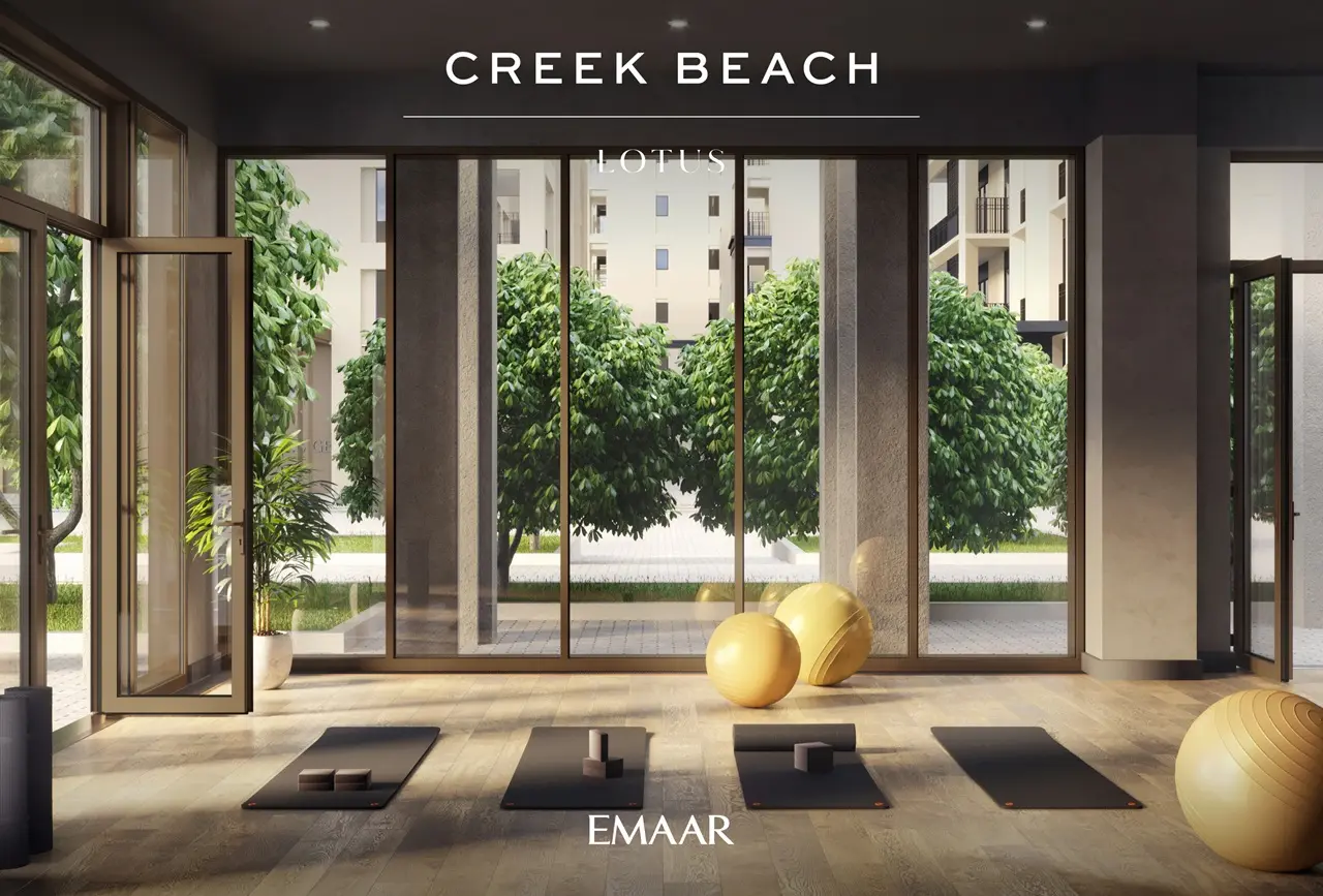 Lotus at Dubai Creek Harbour by Emaar Properties featuring a modern yoga studio with floor to ceiling windows, fitness equipment, and landscaped garden views in Dubai Presented by Tohid Fetrat
