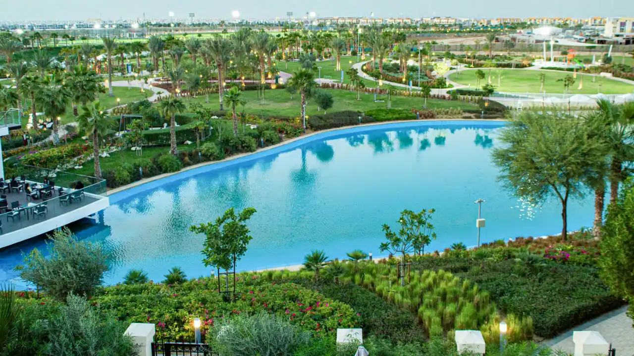 Natura at DAMAC Hills 2 by DAMAC Properties scenic lagoon surrounded by landscaped gardens walking paths and lush green open spaces in Dubai Presented by Tohid Fetrat