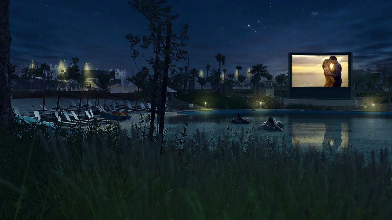 Natura at DAMAC Hills 2 by DAMAC Properties outdoor lagoon cinema with floating movie viewing area landscaped surroundings and evening ambiance in Dubai Presented by Tohid Fetrat