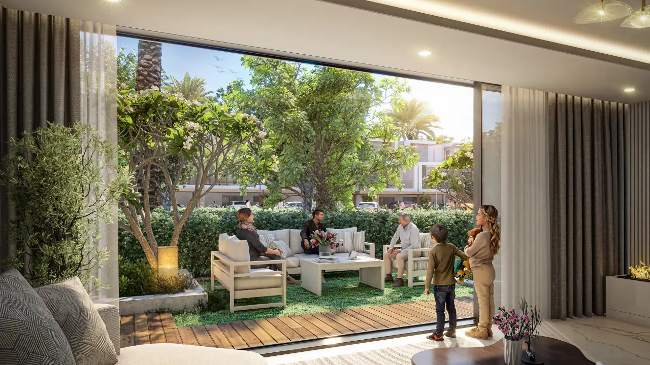 Natura at DAMAC Hills 2 by DAMAC Properties townhouse living area opening to a private garden terrace with landscaped greenery and outdoor seating in Dubai Presented by Tohid Fetrat