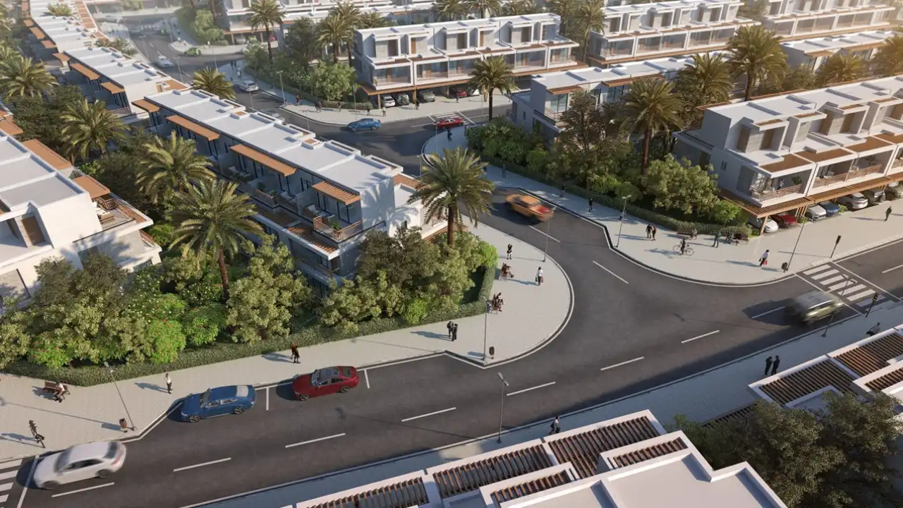 Natura at DAMAC Hills 2 by DAMAC Properties aerial view of contemporary townhouse community with landscaped streets palm trees and modern residential architecture in Dubai Presented by Tohid Fetrat
